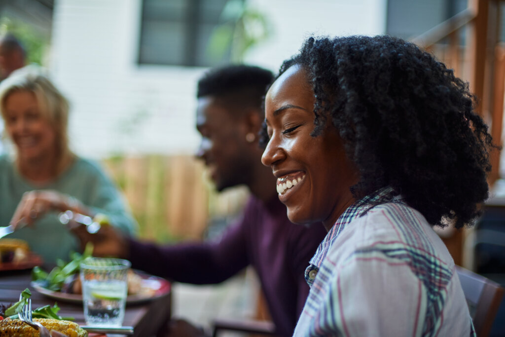 Man and woman smiling while sitting at a table.